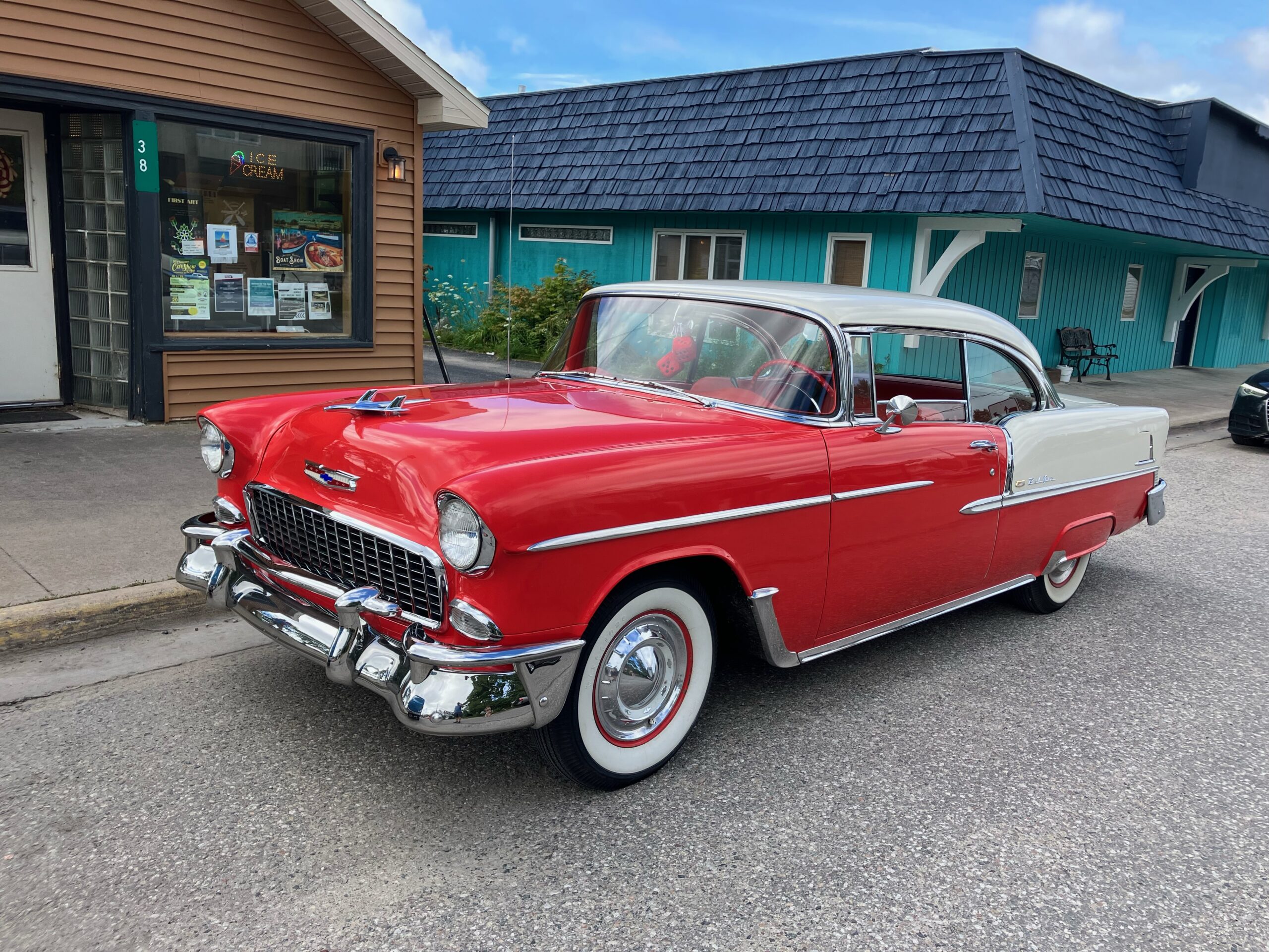 A classic red and white 1955 Chevrolet Bel Air.